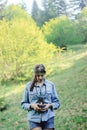 Stylish beautiful girl hipster with analog photo camera in spri Royalty Free Stock Photo