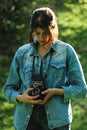 Stylish beautiful girl hipster with analog photo camera in spri Royalty Free Stock Photo