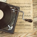 Stylish beautiful old gramophone with manual winding on a wooden table. Royalty Free Stock Photo