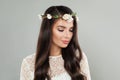 Stylish beautiful woman brunette with long healthy shiny dark brown straight hair, clean skin, makeup and white flower on gray Royalty Free Stock Photo