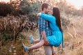 Stylish beautiful young couple standing outdoors at sunset light