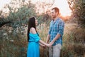 Stylish beautiful young couple standing outdoors at sunset light Royalty Free Stock Photo