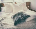Stylish bedroom with black and white pillows on bed Royalty Free Stock Photo