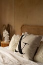 Stylish Bedroom corner with rattan headboard bed and soft pillow decoration with  with plywood wall on the background / cozy Royalty Free Stock Photo