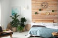 Stylish bedroom interior with green plants. Home design Royalty Free Stock Photo