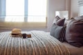 Stylish bedroom interior with striped pillows on bed Royalty Free Stock Photo