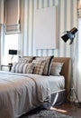 Stylish bedroom interior with striped pillows on bed Royalty Free Stock Photo