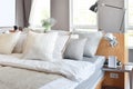 Stylish bedroom interior with white striped pillows on bed Royalty Free Stock Photo