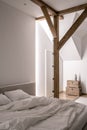 Stylish bedroom in modern style with wooden beams Royalty Free Stock Photo