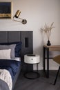 Stylish bedside table in functional bedroom