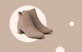 Stylish beige women`s suede boots on an abstract beige background