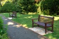 Stylish bench in English summer garden park Royalty Free Stock Photo