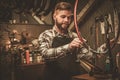 Stylish bicycle mechanic doing his professional work in workshop. Royalty Free Stock Photo
