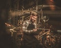 Stylish bicycle mechanic making notes in clipboard in his workshop.