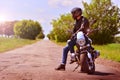 Stylish biker with motorbike stoped on a abandoned road. Motorcycle background. Tonned. Royalty Free Stock Photo