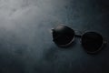 Stylish black aviator sunglasses on dark minimalist background Royalty Free Stock Photo