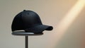 Stylish Black Cap on Stand with Soft Lighting Background Royalty Free Stock Photo