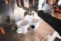 Stylish black espresso making machine brewing two cups of coffee, shooted in cafe. Royalty Free Stock Photo