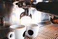 Stylish black espresso making machine brewing two cups of coffee, shooted in cafe. Royalty Free Stock Photo