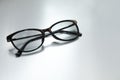 Stylish black eye glasses on white table. Space for text Royalty Free Stock Photo