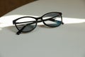 Stylish black eye glasses on white table. Space for text Royalty Free Stock Photo