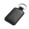 Stylish black leather rectangular keychain with metal ring and stitching detail white background Royalty Free Stock Photo