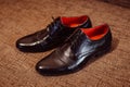 Stylish black leather shoes stand on the brown carpet Royalty Free Stock Photo