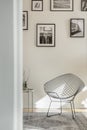 Stylish metal chair in classy white living room interior with tenement house