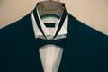 The stylish black suit with white shirt and bow tie on hanger . morning preparations before wedding day. groom outfit Royalty Free Stock Photo