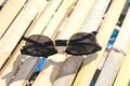 Stylish black sunglasses on bamboo background, elegant eyeglasses accessory isolated on wooden surface