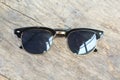 Stylish black sunglasses on wooden background, elegant eyeglasses accessory isolated on wooden surface