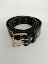 Stylish black unisex leather belt rolled up isolated on a white background