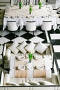 Stylish black and white dining tables and chairs. Minimalist interior in monochrome. Empty restaurant top view.