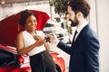 Stylish black woman in a car salon Royalty Free Stock Photo