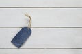 Stylish blank price tag of denim on a string is on a white tabl Royalty Free Stock Photo