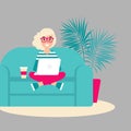 Stylish blond freelancer girl on sofa with laptop. creative hipster work at home.