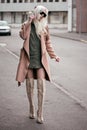 Stylish blonde model walking outdoors