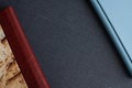 Stylish blue and burgundy photobooks with leather covers and hardcovers lie on a dark gray fabric Royalty Free Stock Photo