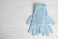 Stylish blue gloves on white wooden background, top view. Autumn clothes Royalty Free Stock Photo