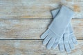 Stylish blue gloves on wooden background, top view. Autumn clothes Royalty Free Stock Photo