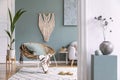 Boho interior design of living room with rattan armchair.