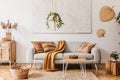 Modern boho interior of living room at cozy apartment with gray sofa. Royalty Free Stock Photo