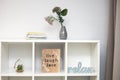 Stylish bookshelf with decorations for home on a white wall Royalty Free Stock Photo