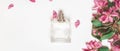 Stylish bottle of perfume of flowers on white background. creative trendy flat lay with copy space. top view. perfumery and floral