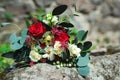 Stylish bouquet with red and white flowers and eucalyptus branches. Unusual wedding bohemian floristic flowers