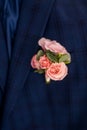 Stylish boutonniere on the groom`s jacket, wedding day, beautiful flower boutonniere, wedding concept Royalty Free Stock Photo