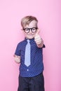 Stylish boy in shirt and glasses with big smile. School. Preschool. Fashion. Studio portrait over pink background Royalty Free Stock Photo