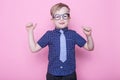 Stylish boy in shirt and glasses with big smile. School. Preschool. Fashion. Studio portrait over pink background Royalty Free Stock Photo