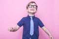 Stylish boy in shirt and glasses with big smile. School. Preschool. Fashion. Studio portrait over pink background Royalty Free Stock Photo