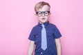 Stylish boy in shirt and glasses with big smile. School. Preschool. Fashion. Studio portrait over pink background Royalty Free Stock Photo